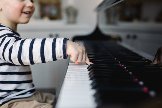 toddler playing a piano