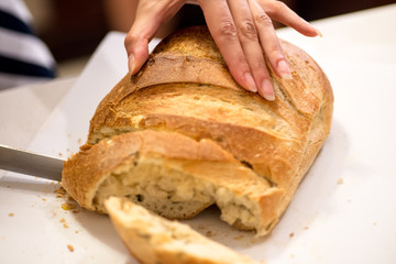 Using kitchen knife to cut bread