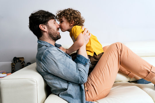 Happy father and his son having fun at home