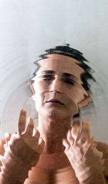 Woman portrait distorted by the ripples in the water