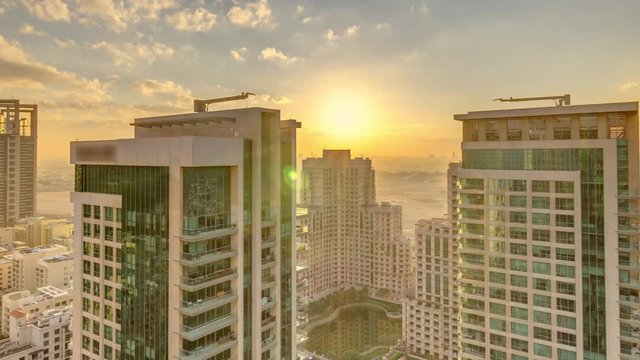 Sunrise over towers in Greens district aerial view from top timelapse. Residential and office buildings from above near golf cource