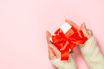 Christmas flat lay background on pink with present box.