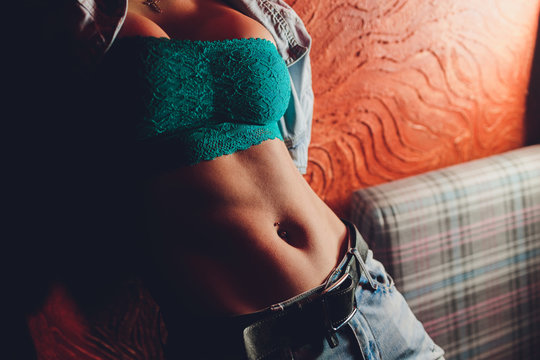 The belly of a slim woman close up. Female press. A drop of sweat on a thin sports stomach.