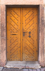 Wooden doors to the house with forging