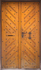 Wooden doors to the house with forging
