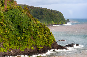 Large volcanic cliffs with crashing waves along the coast of Maui Hawaii