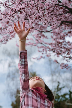Girl looking at Blossoms
