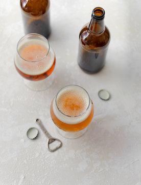 Stock photo of two glasses of pale ale on light background