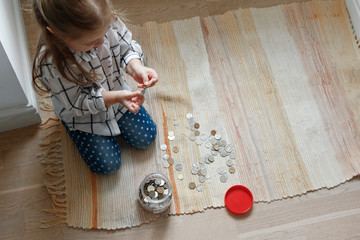 Girl with coins and moneybox