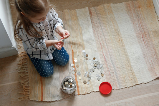 Girl with coins and moneybox