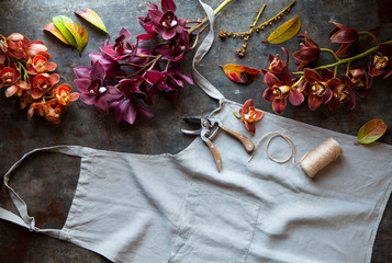 Flowers, apron and gardening tools as seen from above