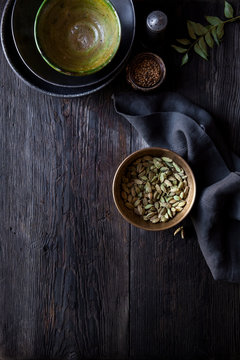 Dark table setting with crockery and spices