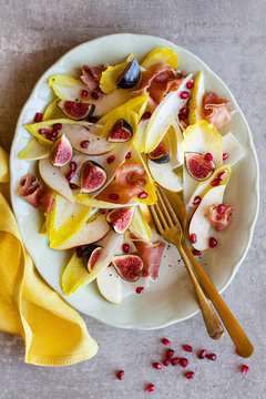 Endive, fig, prosciutto ham, pear and pomegranate salad