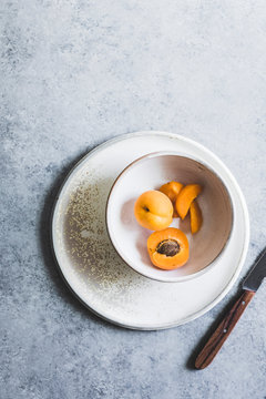 A sliced apricot in a bowl