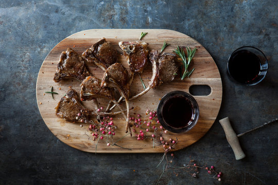 Pan seared lamb cutlets on wooden platter
