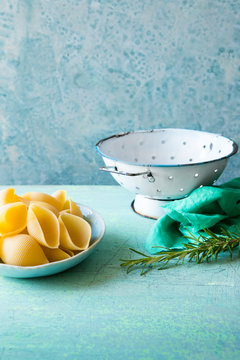 Old colander with herbs and pasta shells