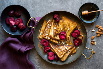 Delicious french toast with roasted plums and maple syrup