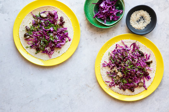 Vegan black bean tacos with cabbage slaw, mushrooms, sesame seeds and cilantro