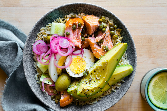 Salmon rice bowl with avocado, egg and capers