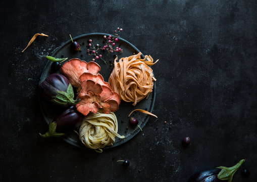 Homemade pasta and a selection of cooking ingredients