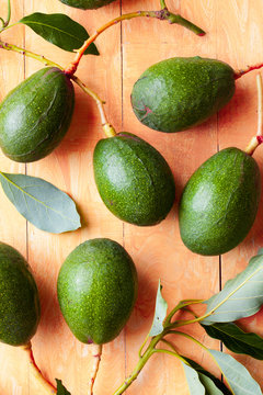 Whole ripe avocados on a bright background