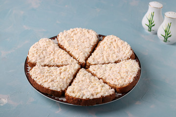 Sandwiches with cheese , eggs and crab sticks on light blue background, Closeup
