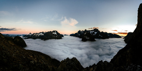 Dark mountain range above clouds