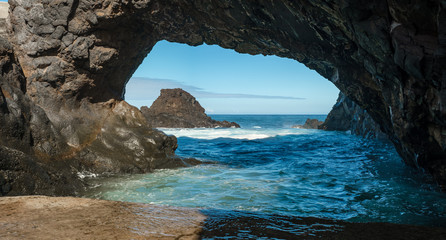 natural arch in rock and waves