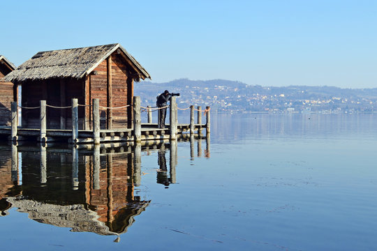 photographer on ancient lake dwellings in Viverone Lake, Piedmont. Italy