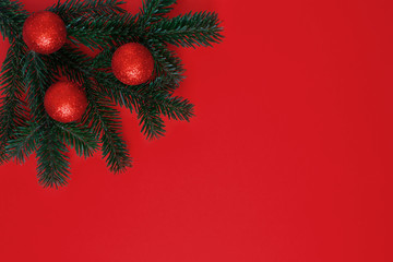 Christmas border. Winter holiday background with decorative border of realistic Christmas tree branches with red and sparkling balls . Vector illustration.