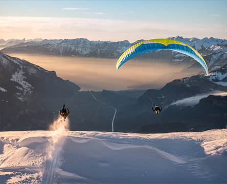 skier and paraglider in the air