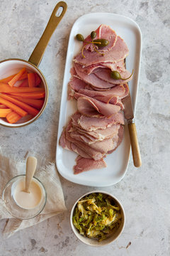 Delicious Corned Beef with sauteed cabbage, carrots, caper berries and sauce.