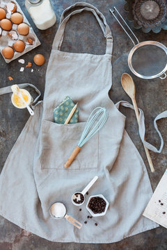 Cooking and baking kitchen apron with ingredients and kitchen utensils