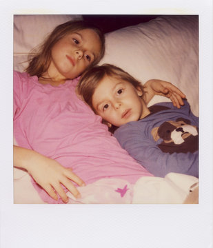 Polaroid Portrait of Tired Siblings Ready For Bed