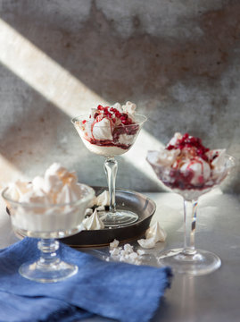 Desserts: crushed meringues with whipped cream, ruby red pomegranate molasses and pomegranate rubies