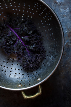 Red kale leaf in colander