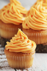Cupcakes with orange icing on top	