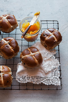 Hot cross buns with a pot of jam