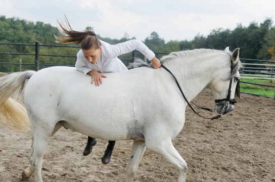Active woman jumping on a horse