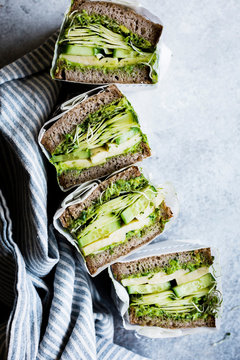 A healthy cheese and green salad sandwich on brown bread, with cucumber and cress.