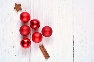 small red christmas tree made with bauble wooden star and cinnamon on white wooden background