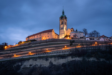 Scenic view of the historic old town Melnik in the Central Bohemia at twilight. The gothic catholic...