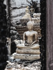 Fototapeta na wymiar Closeup Shot at Budha Statue in A Burned / Burnt Temple from Electricity Short Circuit Accident or Careless Behavior.