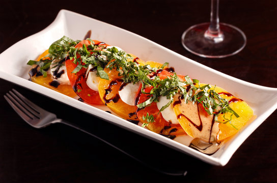 Caprese Salad With Heirloom Tomatoes Topped With Fresh Basil