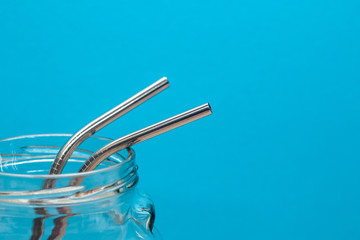 metal straws and cleaning brush in glass jar