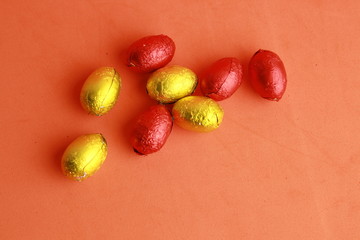 chocolate easter eggs, wrapped in yellow and red paper