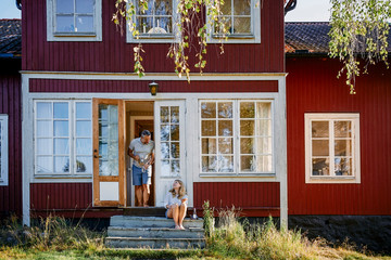 Man and woman talking at entrance of log cabin