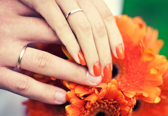 Fototapeta premium Hands of newlyweds with wedding rings