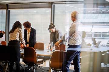 Legal professionals working at conference table in board room