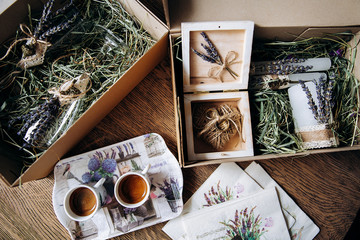 Valentines day romantic dinner table setting marry me wedding engagement ring in box with lavender gift cup of coffee surprise on pink background with copyspace. Love flower gift woman making proposal